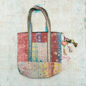 Vintage Kantha tote bag with patchwork stitching and a handmade tassel made from reclaimed materials.