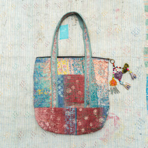 Vintage Kantha tote bag with patchwork stitching and a handmade tassel made from reclaimed materials.