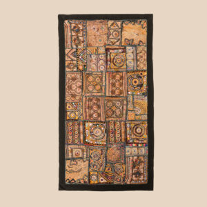 Vintage embroidered textile wall hanging with intricate handwork and visible signs of age.