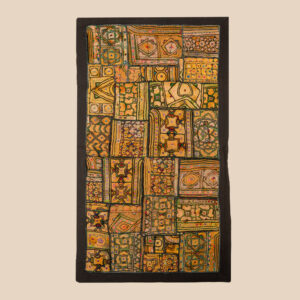 Vintage embroidered textile wall hanging with intricate handwork and visible signs of age.