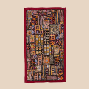 Vintage embroidered textile wall hanging with intricate handwork and visible signs of age.