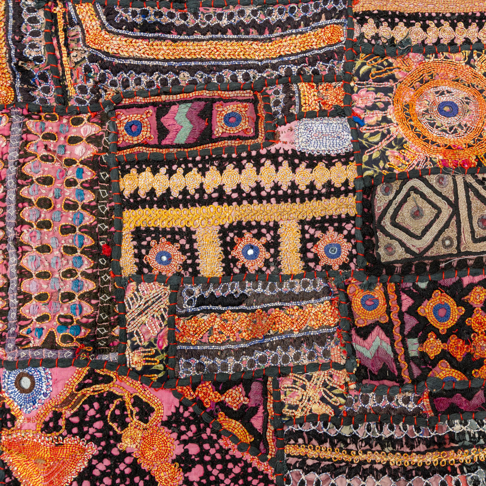 Vintage embroidered textile wall hanging with intricate handwork and visible signs of age.