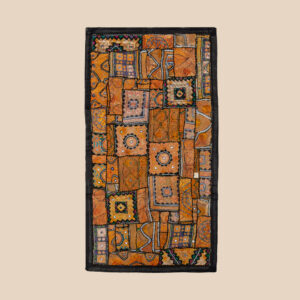 Vintage embroidered textile wall hanging with intricate handwork and visible signs of age.