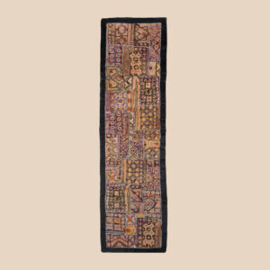 Vintage embroidered textile wall hanging with intricate handwork and visible signs of age.