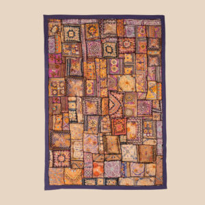 Vintage textile wall hanging with intricate jari embroidery and visible signs of age.